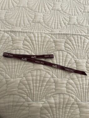 Hermes chocolate brown ribbon with iconic logo.